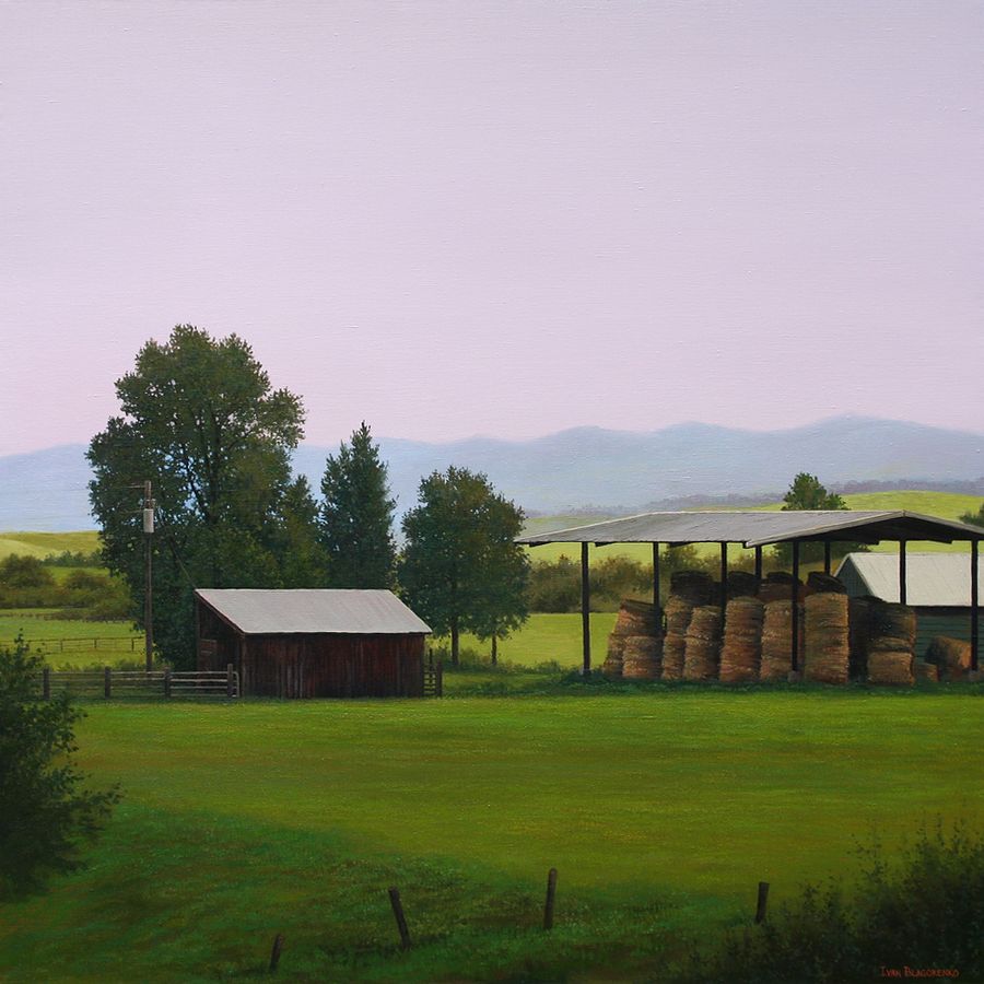 Calm summer evening with shed and hay stacks